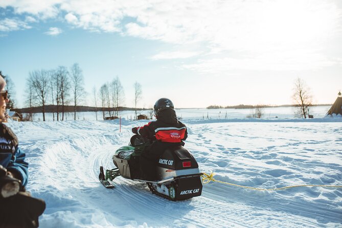 Family Snowmobiling in Rovaniemi, Apukka Resort - Riding into the snowy forest near Apukka