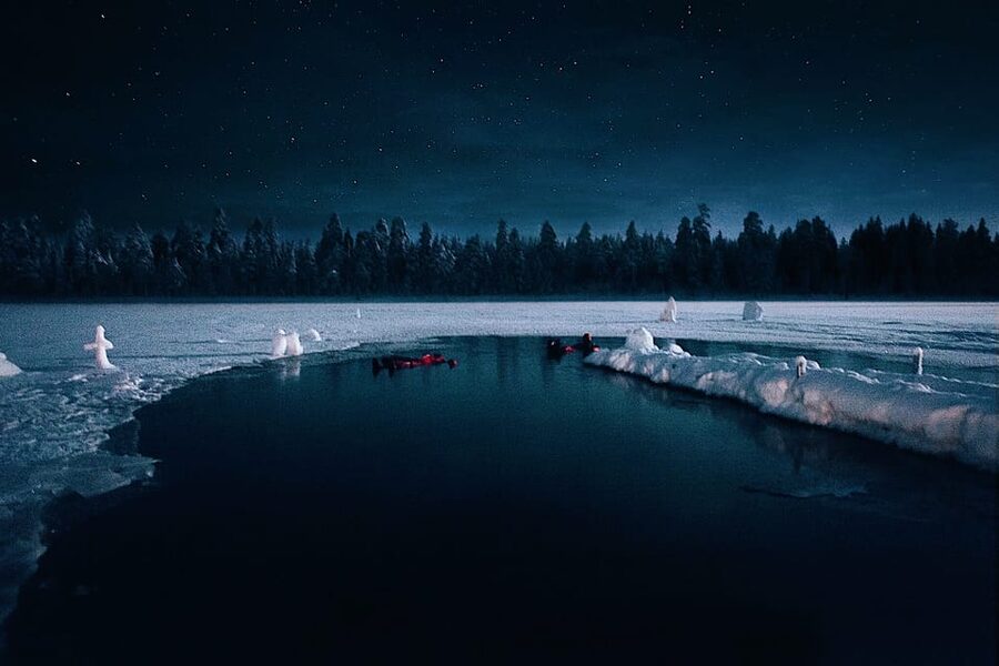 From Rovaniemi: Ice Floating under Aurora Borealis - A frozen lake, a rescue suit, and an Arctic sky