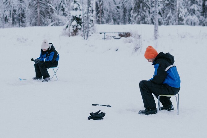 Ice Fishing by Snowmobile in Levi - Drilling through a frozen lake