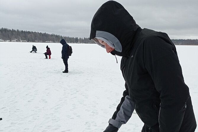 Ice fishing experience with Backpacker Helsinki Tour - Standing on the ice and learning the basics