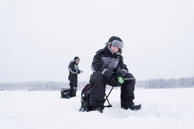 Ice Fishing on a Frozen Lake in Levi - Drilling through the ice and setting up