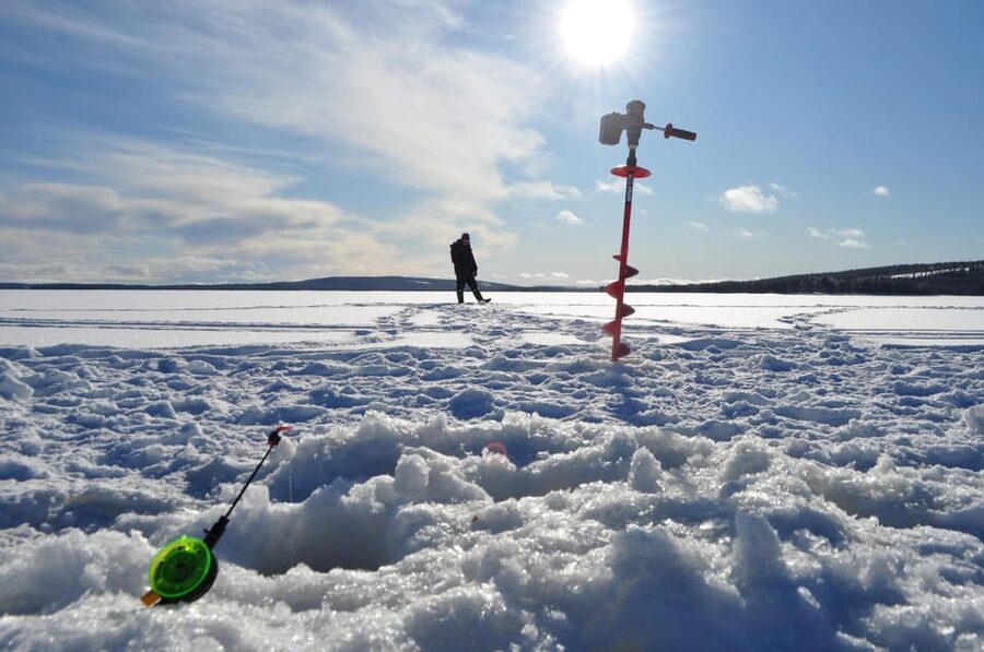 Ice fishing program in Lapland - Learning to cut through thick lake ice