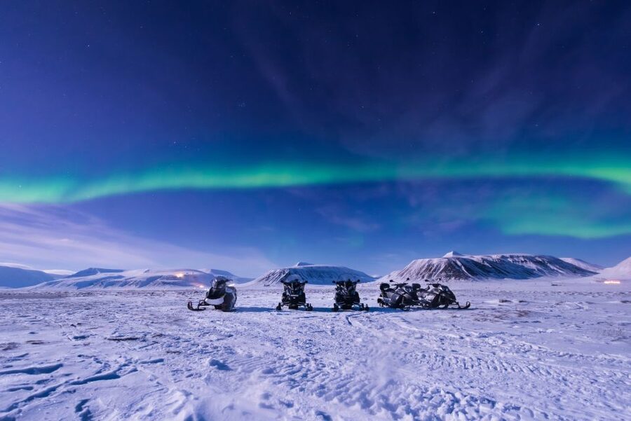 Rovaniemi: Aurora Borealis Snowmobile Safari with Campfire - Rovaniemi after dark, with the throttle open
