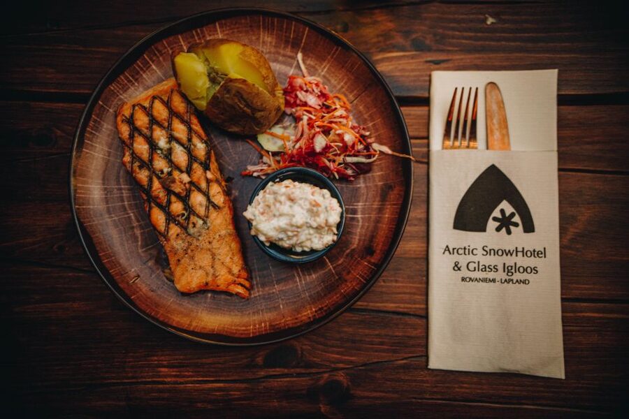 Rovaniemi: Snow Hotel Tour with Food by the Fire - Watching salmon cook over an open fire