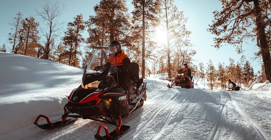 Saariselkä: Snowmobile Ride with Hot Drinks - Riding two to a snowmobile through the forest