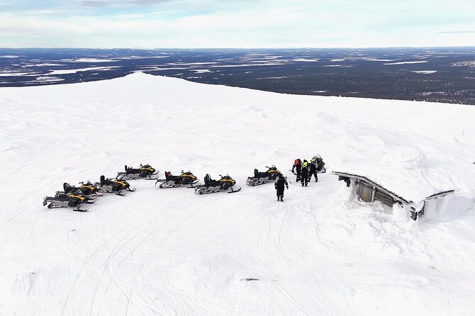 Snowmobile Rides Through Kumputunturi Fell in Kittilä, Finland - Warming up beside the open fire